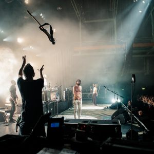 Simon Neil tosses guitar to Richard Pratt, Credit - Carla Mundy