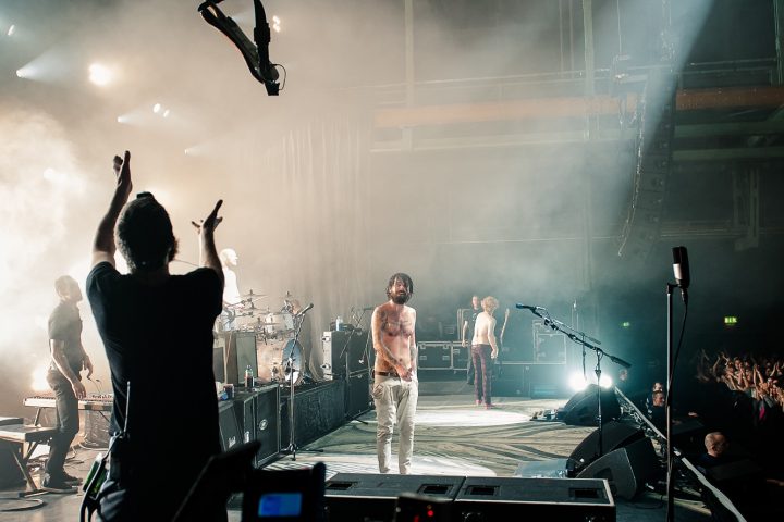 Simon Neil tosses guitar to Richard Pratt, Credit - Carla Mundy