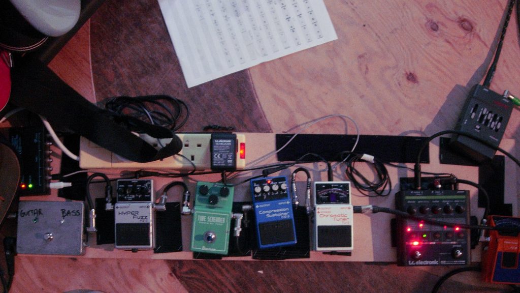 BOSS effects pedals shown on Portishead bass veteran Jim Barr's pedalboard include an FZ-2 Hyper Fuzz, CS-3 Compression Sustainer, and TU-2 Chromatic Tuner.