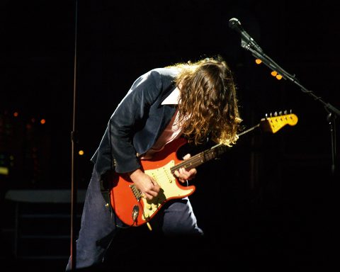 John Frusciante playing Fiesta Red Fender Stratocaster on stage with the Red Hot Chili Peppers at Voodoo Music Experience 2006, New Orleans.