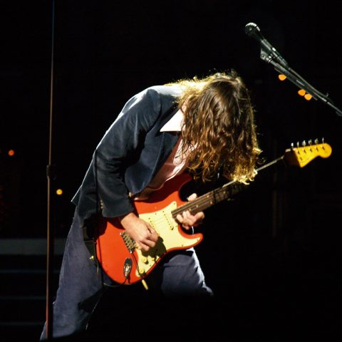 John Frusciante playing Fiesta Red Fender Stratocaster on stage with the Red Hot Chili Peppers at Voodoo Music Experience 2006, New Orleans.