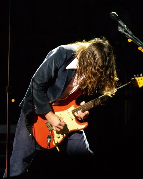 John Frusciante playing Fiesta Red Fender Stratocaster on stage with the Red Hot Chili Peppers at Voodoo Music Experience 2006, New Orleans.