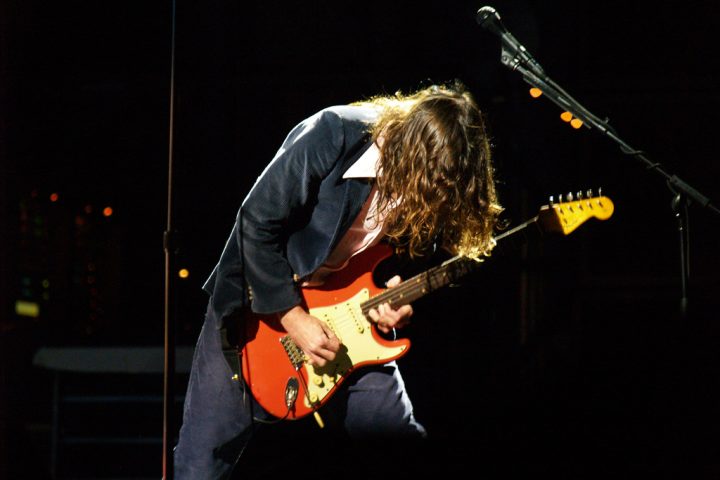 John Frusciante playing Fiesta Red Fender Stratocaster on stage with the Red Hot Chili Peppers at Voodoo Music Experience 2006, New Orleans.