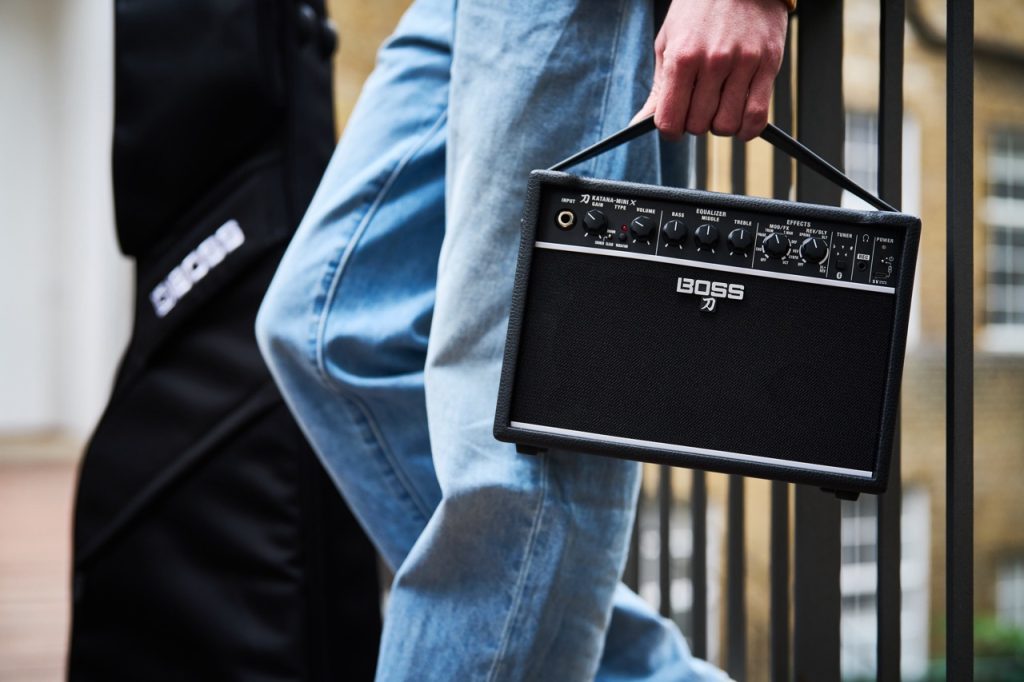 BOSS Katana-Mini X portable amplifier carried by musician