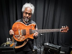 Pat Metheny's guitar tech, Andre Cholmondeley pictured at the Barbican Hall, London, on November 15, 2025, holding Metheny's Roland GR-303 Guitar Controller.