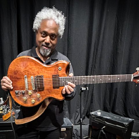 Pat Metheny's guitar tech, Andre Cholmondeley pictured at the Barbican Hall, London, on November 15, 2025, holding Metheny's Roland GR-303 Guitar Controller.