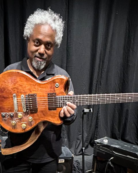 Pat Metheny's guitar tech, Andre Cholmondeley pictured at the Barbican Hall, London, on November 15, 2025, holding Metheny's Roland GR-303 Guitar Controller.