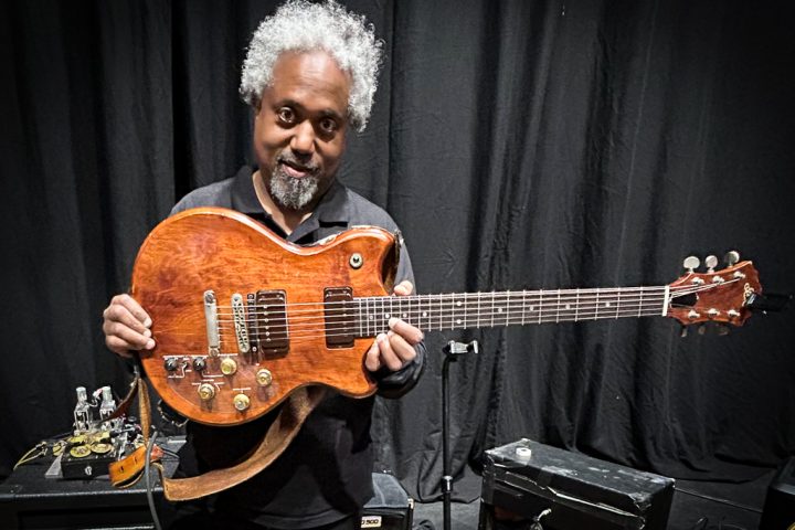 Pat Metheny's guitar tech, Andre Cholmondeley pictured at the Barbican Hall, London, on November 15, 2025, holding Metheny's Roland GR-303 Guitar Controller.