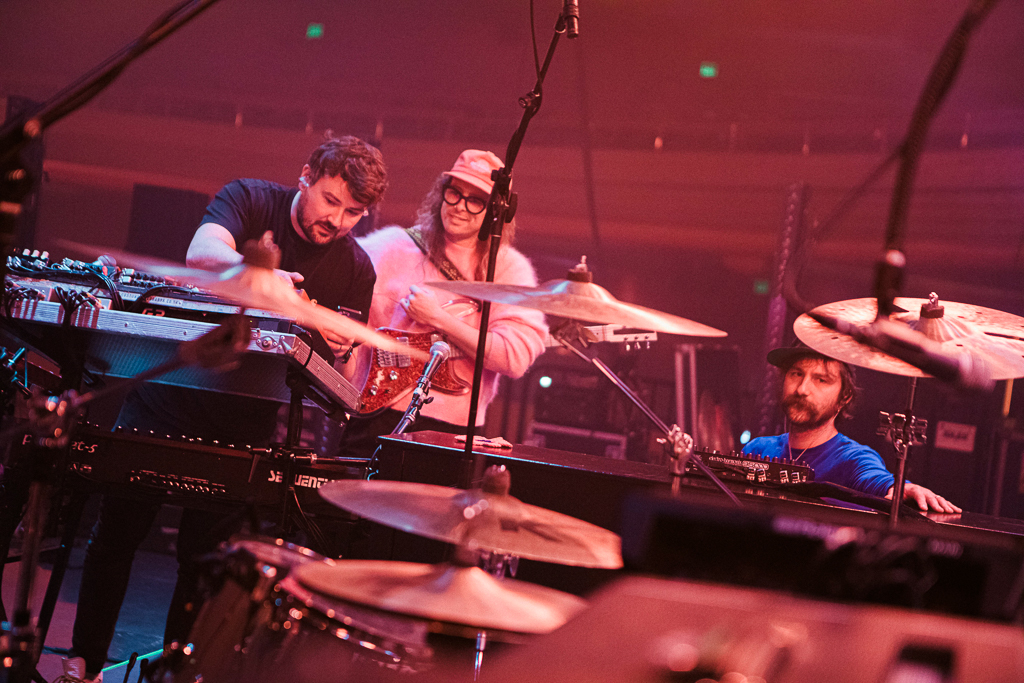 Guitar tech Gavin Maxwell (left) with IDLES guitarists Lee Kiernan (center) and Mark Bowen.