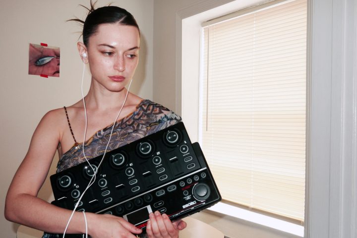 Oxis holding her BOSS RC-505mkII Loop Station