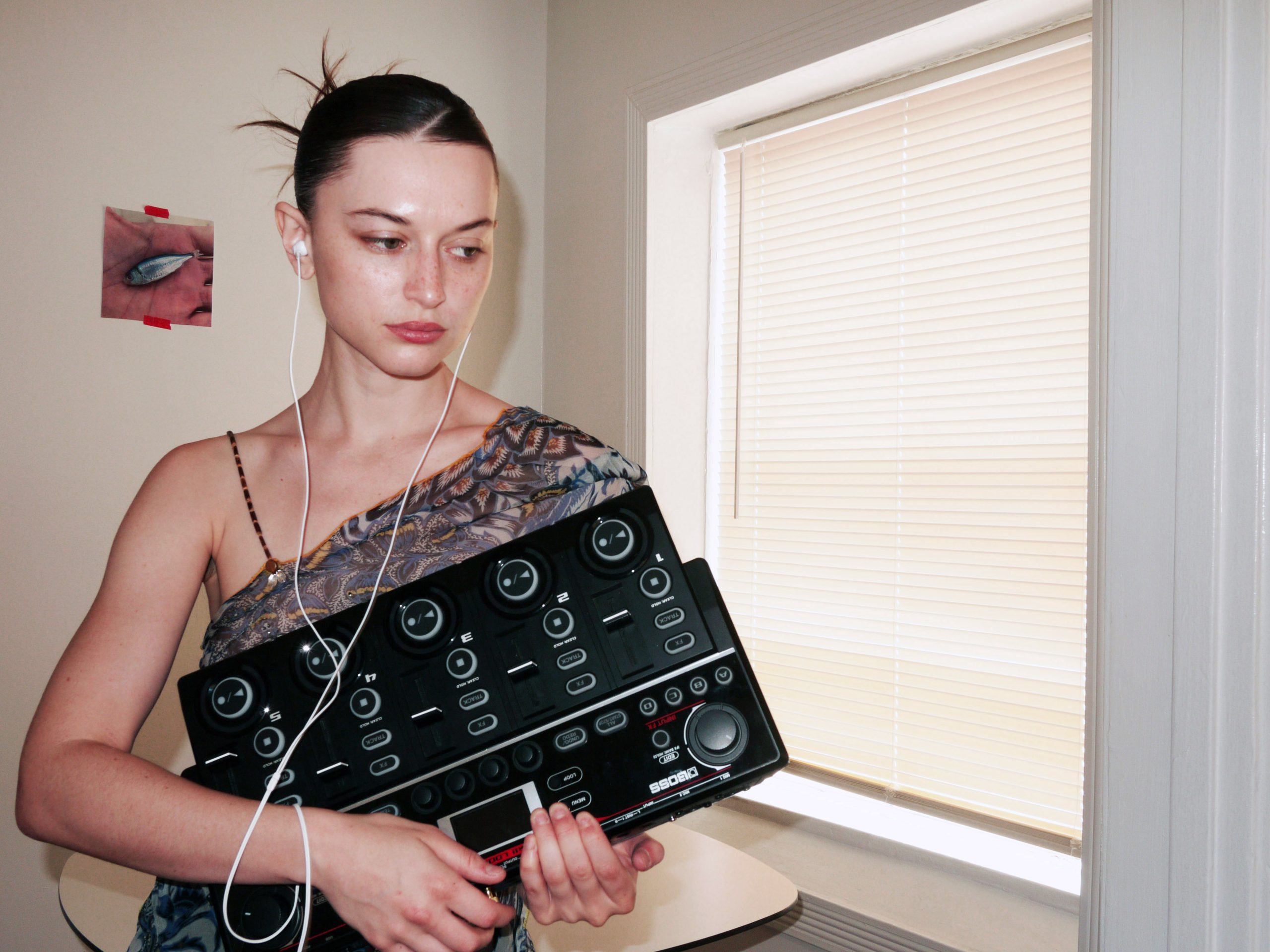 Oxis holding her BOSS RC-505mkII Loop Station