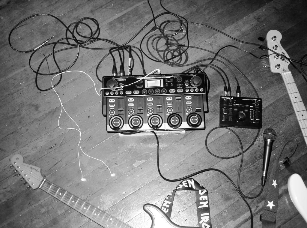 Oxis' rig comprising the BOSS RC-505mkII Loop Station, Roland VT-4 Voice Transformer, and electric bass