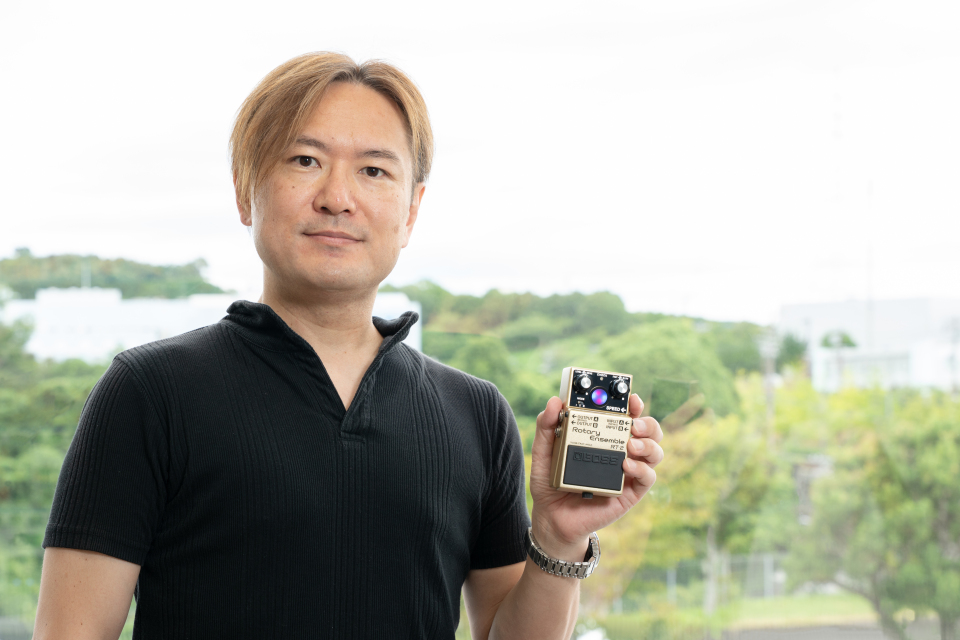 BOSS Engineer Takeshi Mitsuhashi holding the RT-2 Rotary Ensemble