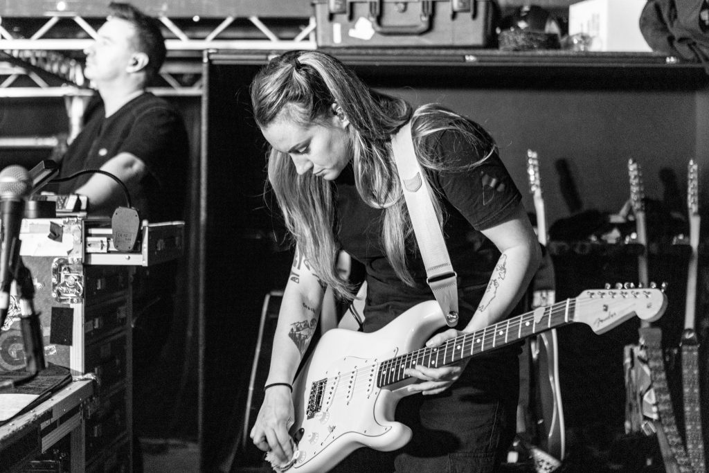 Sara Ferrero polishes Rick Astley's Fender Stratocaster